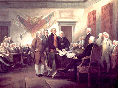 A historical painting depicts members of the Continental Congress presenting a document to a seated figure. The room is filled with men in 18th-century attire, and there&apos;s a large wall mural in the background depicting flags and symbols.